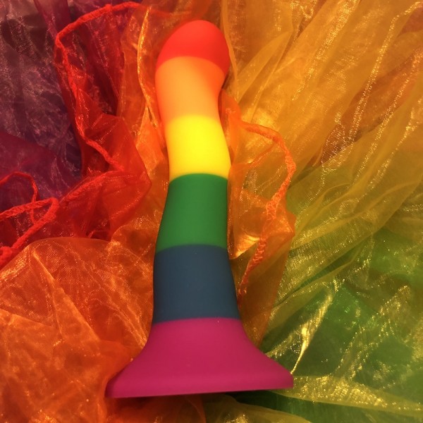 Pride colours wave dildo on bed of rainbow tulle