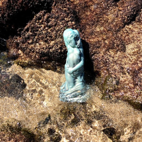 Sea green mermaid dildo against rocks